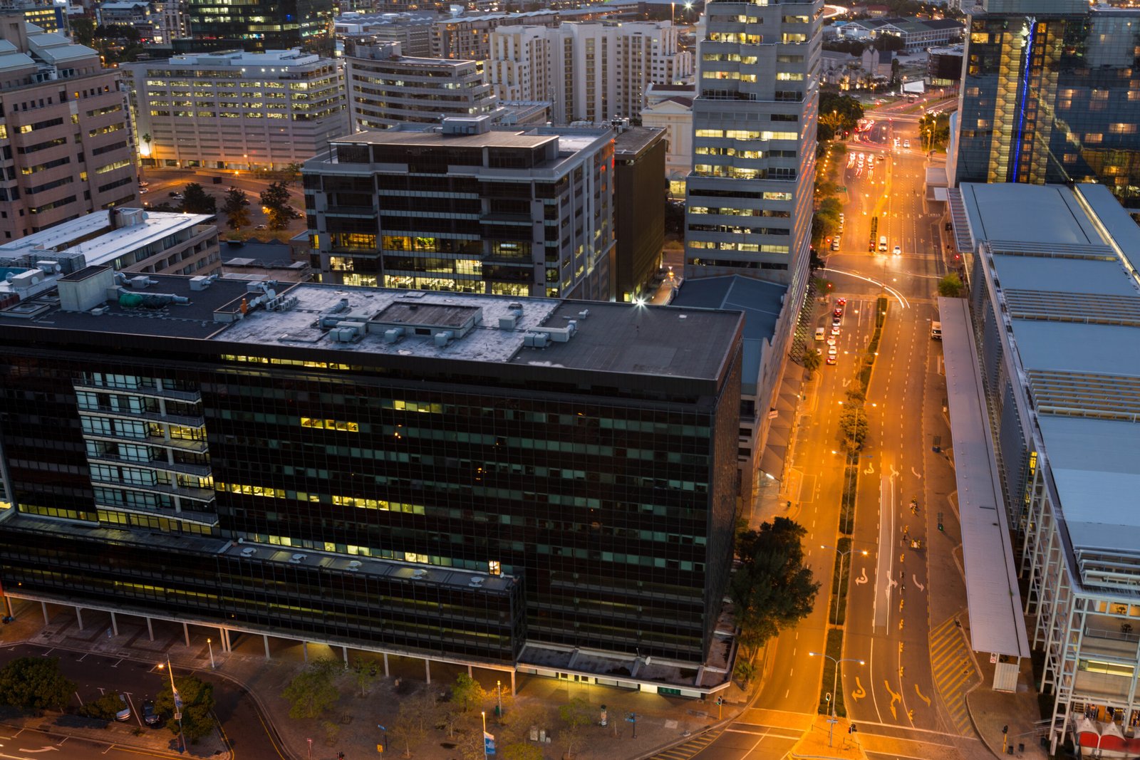 Aerial view of streets and office building in business district at night