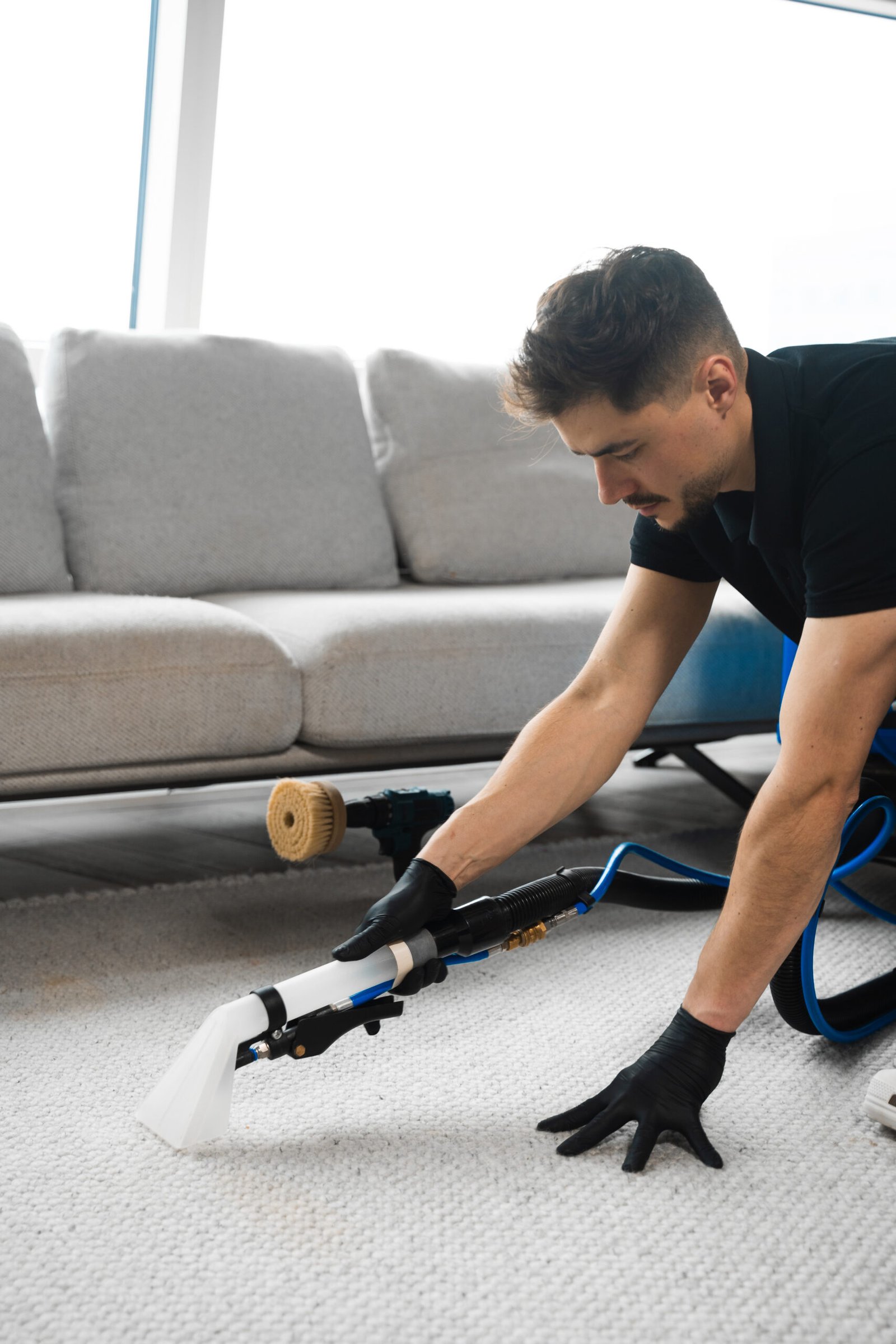 Cleaning the carpet at home using drill and brush. Easy removal of stains on carpet with drill and brush. Smearing detergent deep into fibers to clean carpet with drill and brush.